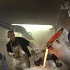 At the Foundry - The pouring of the liquid bronze into the mold